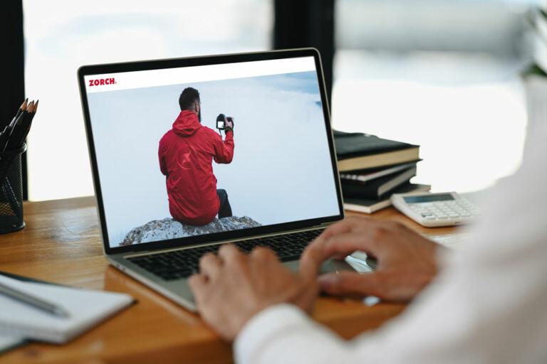 Client on laptop navigating to Zorch website, Fossa Apparel and Zorch Create Custom Promotional Products on Demand